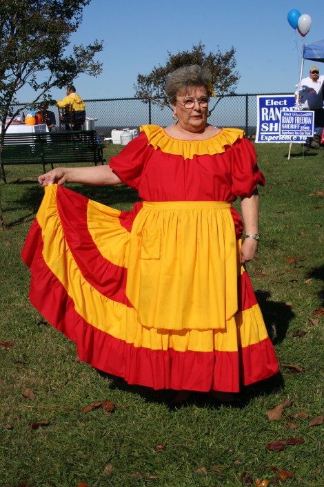 woman dressed in orange and gold dress | Fat Mama's Tamales