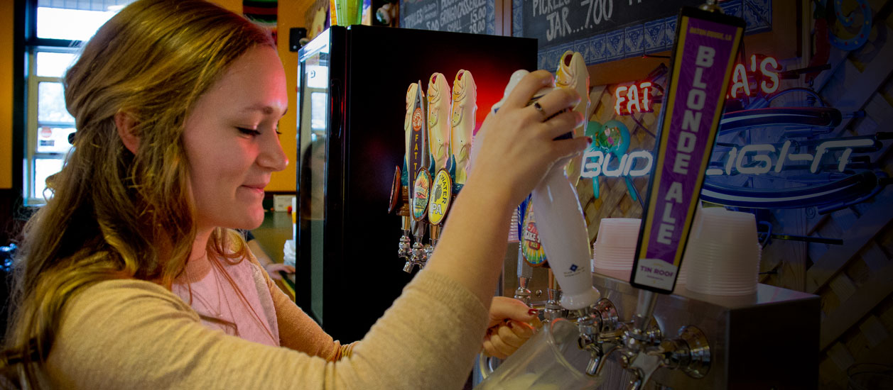 Fat Mama's Tamales co-worker pulling a draft beer | Order Tamales Online | Fat Mama's Tamales | Natchez, MS